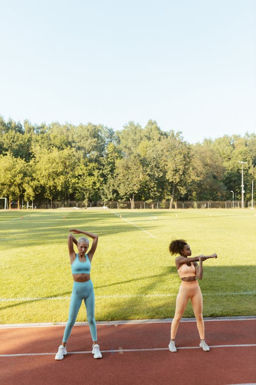 Photo of Women in Sports Wear Stretching