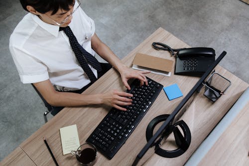 An Employee Typing on His Keyboard