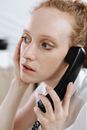 Woman in White Shirt Holding Black Telephone