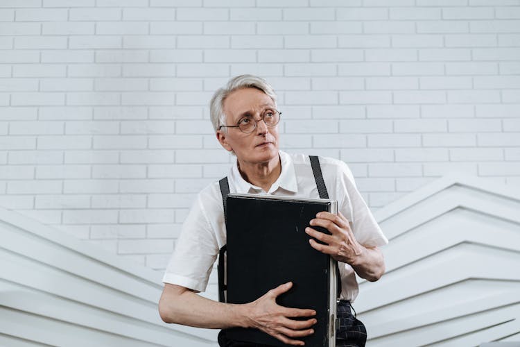 An Elderly Man Carrying A Briefcase