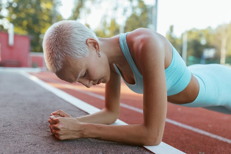 Woman In Blue Workout Clothes Planking