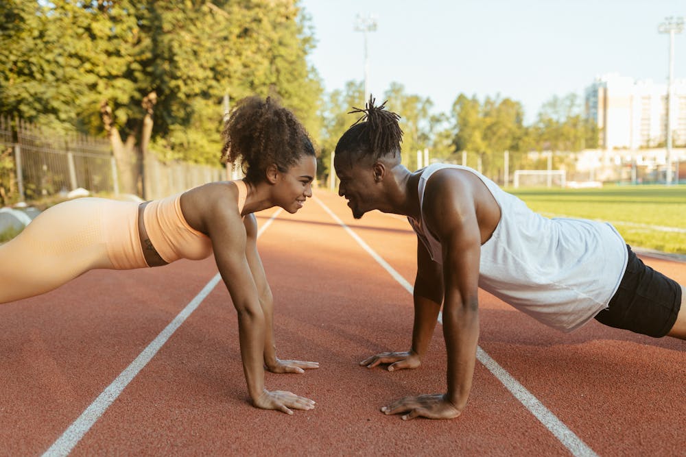 Man and woman doing push-ups outdoors