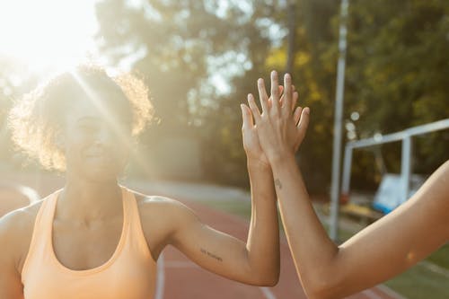 Free Smiling Woman Giving a High Five Stock Photo