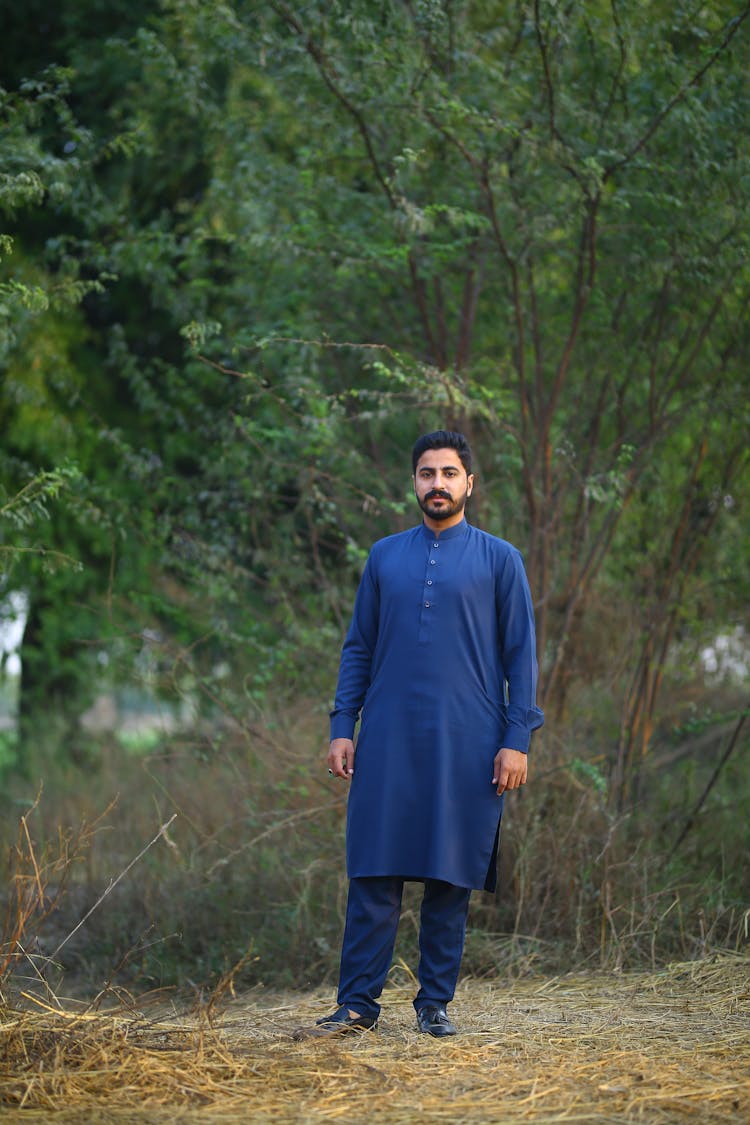 Bearded Man In Blue Shalwar Kameez Standing On Grass Field