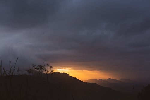 Free A dramatic sunset over Sri Lankan mountains with a moody sky. Stock Photo