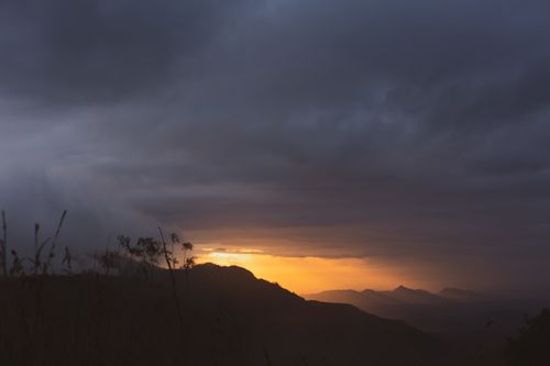 Free A dramatic sunset over Sri Lankan mountains with a moody sky. Stock Photo