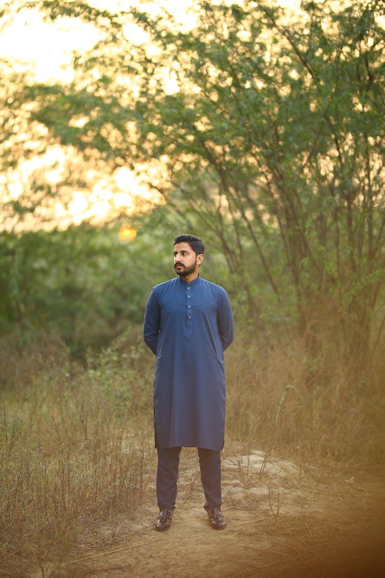 Bearded Man In Blue Shalwar Kameez Standing On Grass Field