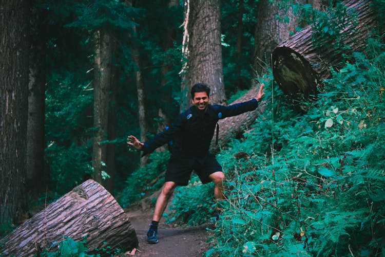 Man Wearing Black Jacket Standing On Forest