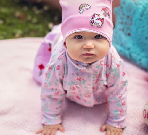 Free Selective Focus of a Cute Baby in Pink Clothes Stock Photo