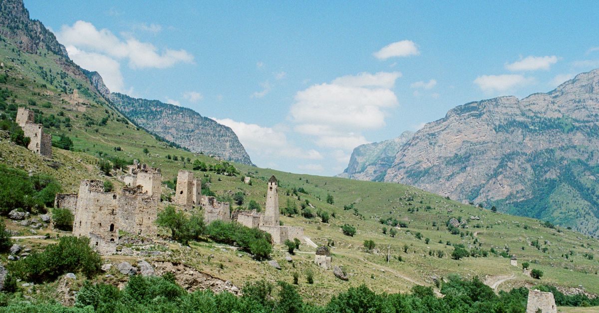 mountain village in the Caucasus region with stone towers and green valley