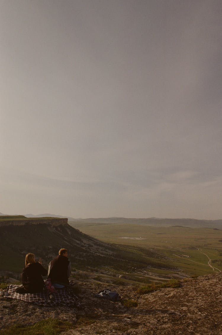 Man And Woman Having A Picnic On The Top Of A Hill 