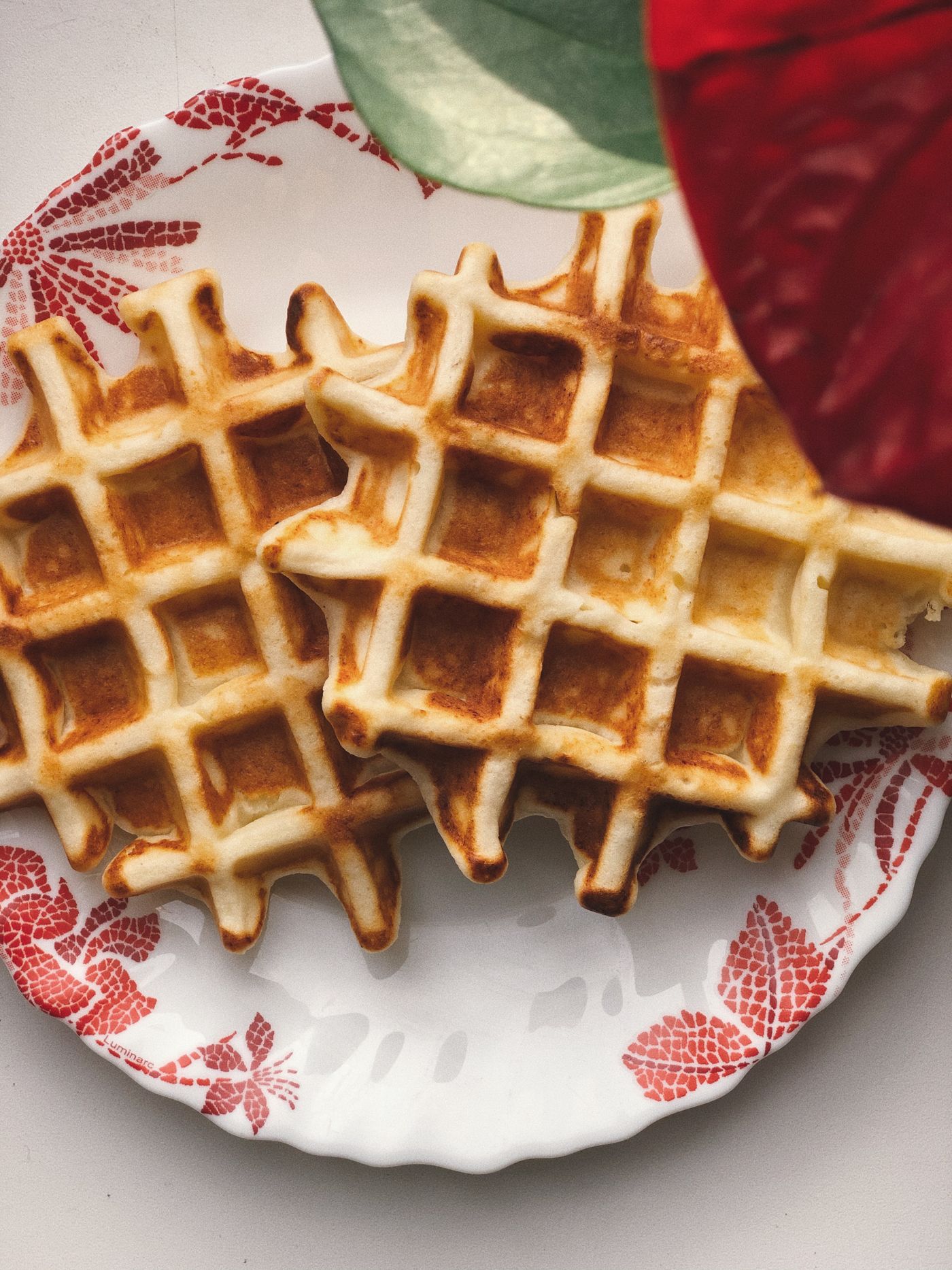 Golden waffles served on a patterned plate ready to be reheated and eaten