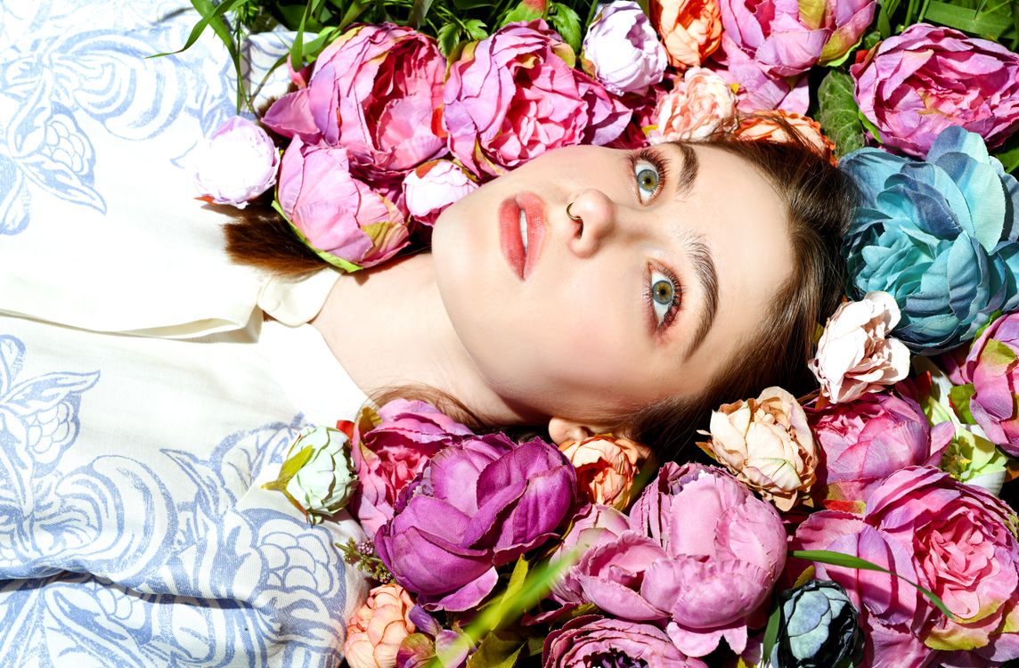 A Woman Surrounded by Flowers · Free Stock Photo