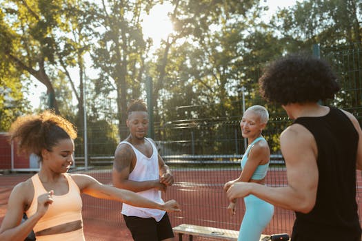Energetic group of diverse young adults enjoying a game of basketball on a sunny day.