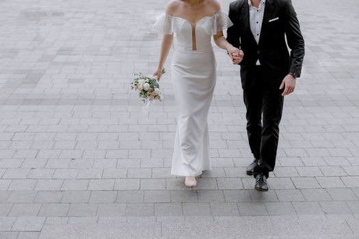 Bride and groom elegantly walking together, symbolizing unity and love.