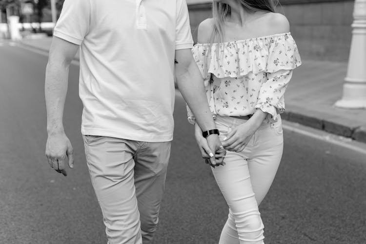 Man And Woman Holding Hands While Walking 