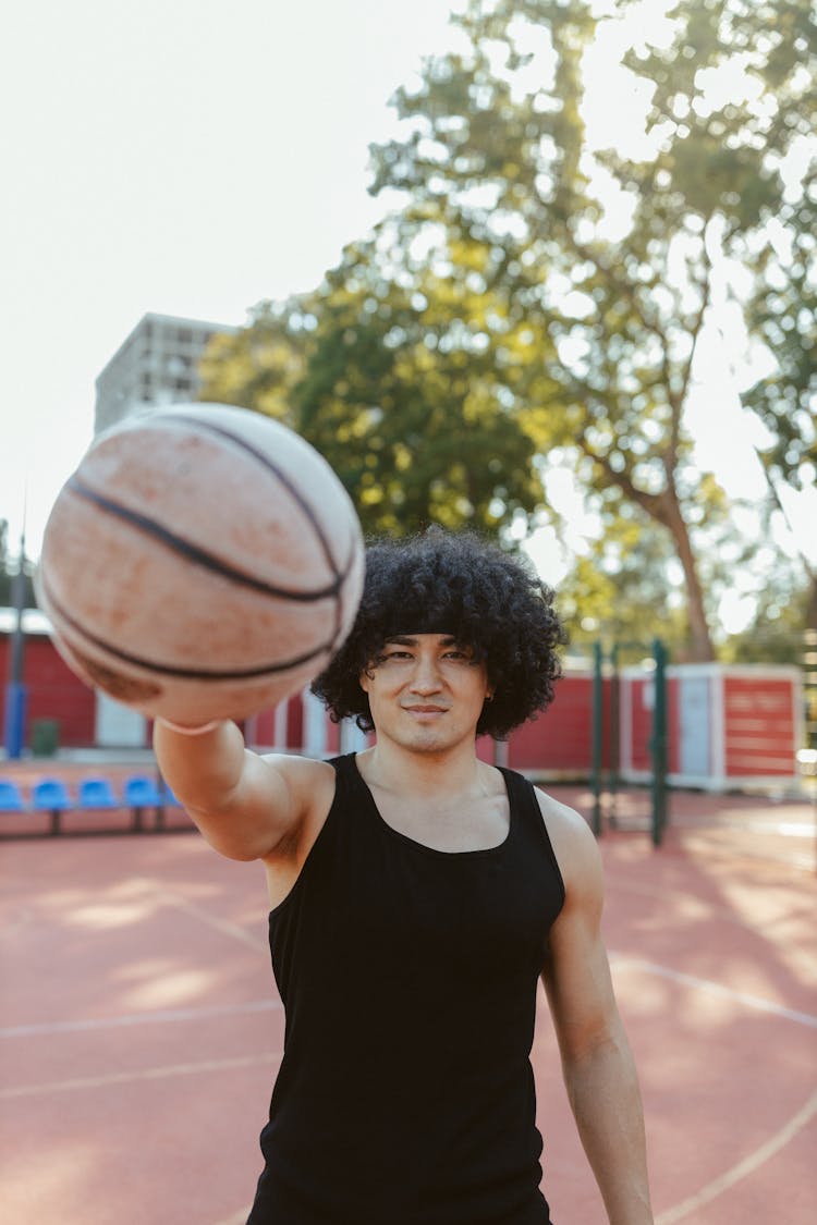 Man With Afro Hair Holding A Ball