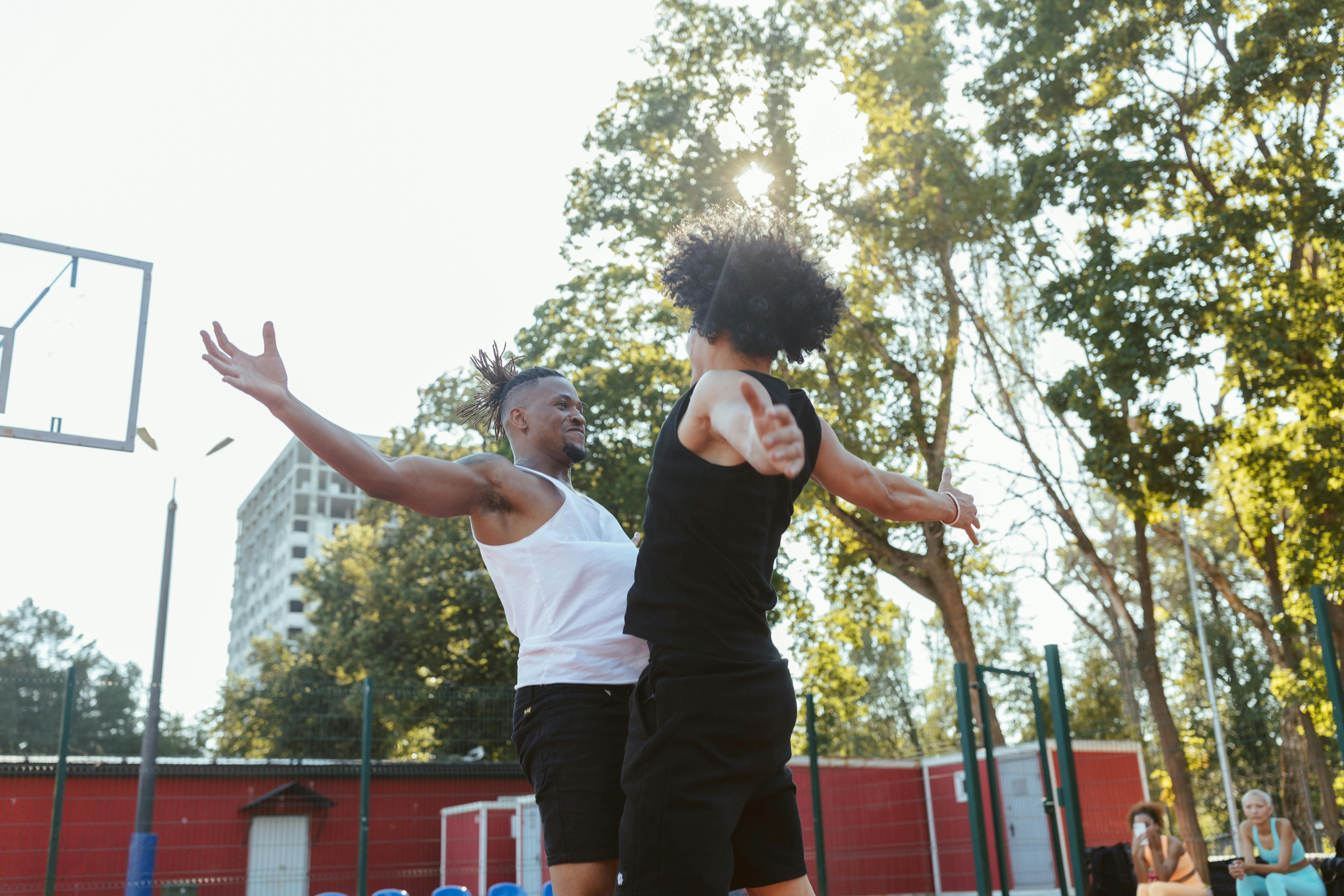 low angle shot of two men playing basketball