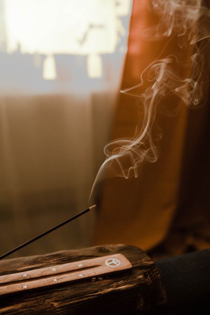 A calming indoor scene with incense smoke creating a peaceful ambiance, perfect for relaxation.