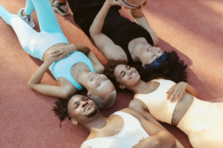 Group Of People Lying At A Basketball Court