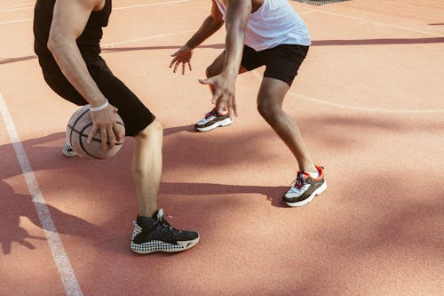Men Playing Basketball on Clay Court
