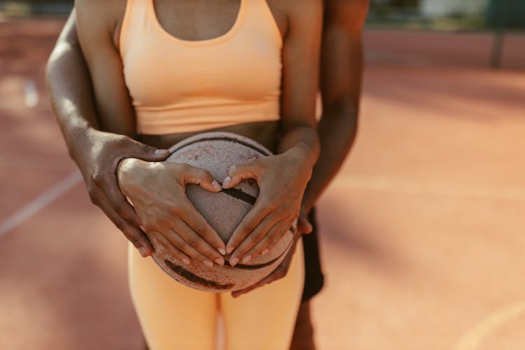 Couple Holding A Ball Together