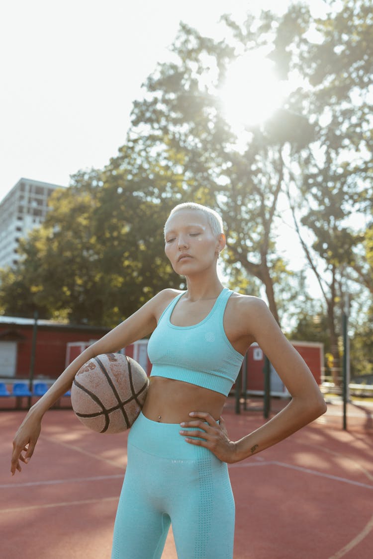 A Woman With Short Hair Holding A Ball