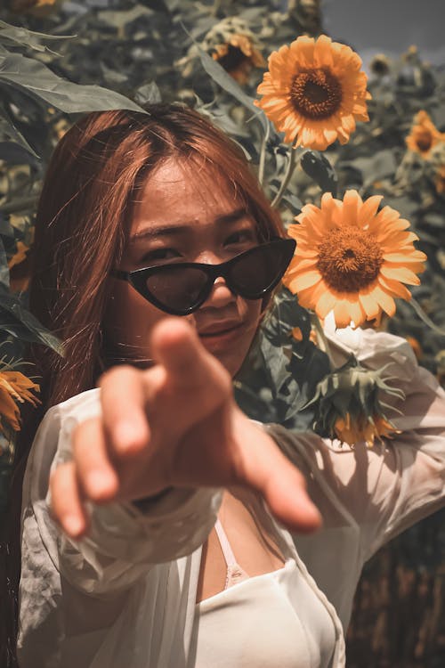 Woman Standing Beside Sunflower Plants