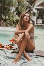 Woman Sitting on Poolside