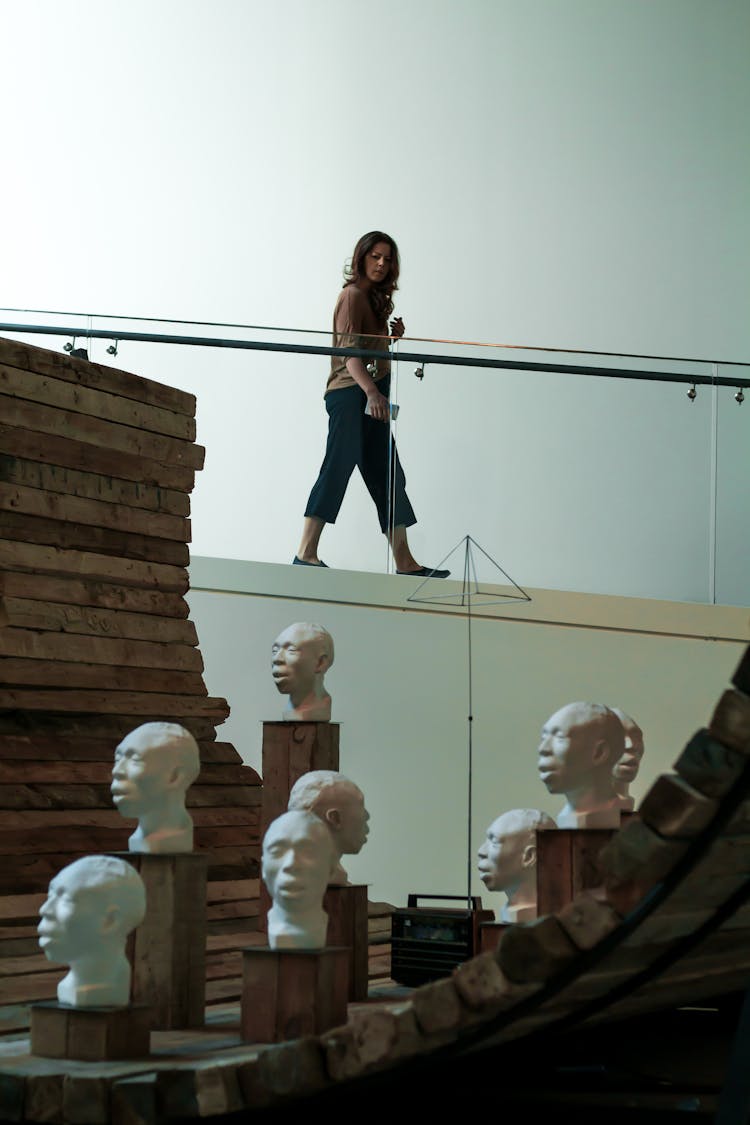 Woman At Istanbul Biennial Looking At Sculptures 