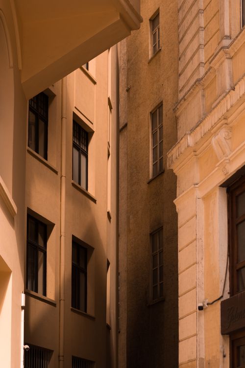 Free A warm-toned urban architectural scene highlighting facades and shadows. Stock Photo