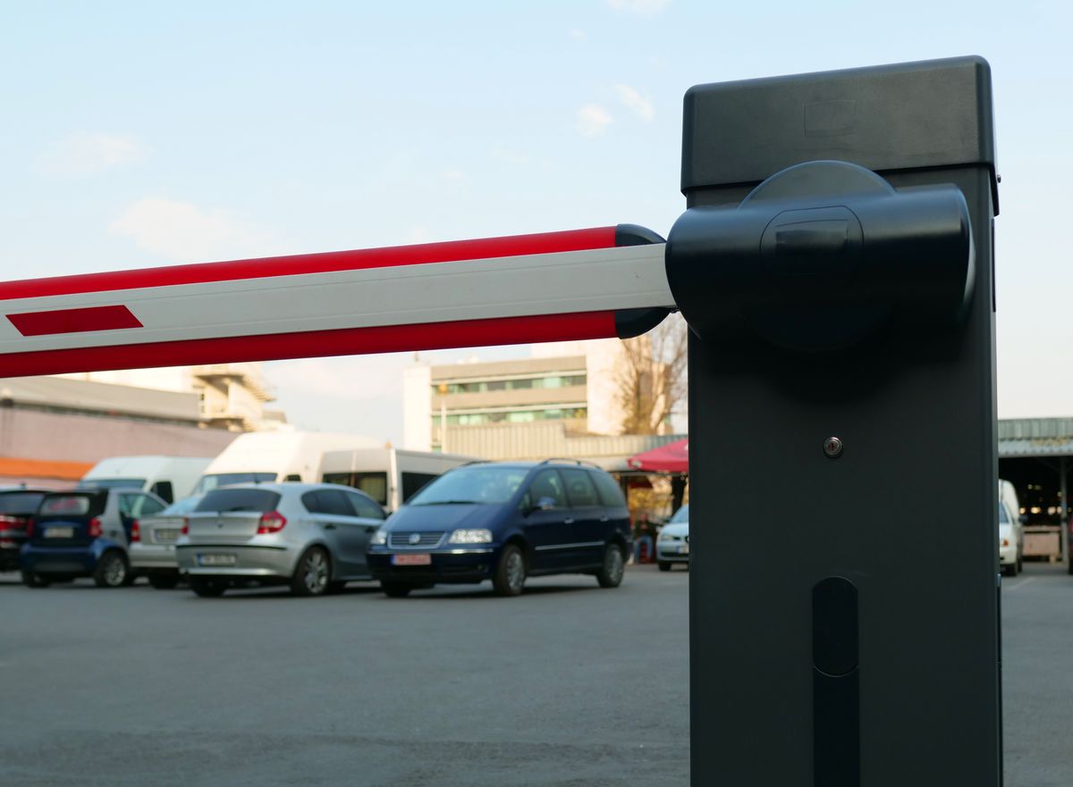 Automatic barrier gate at a car park exit with vehicles waiting behind it