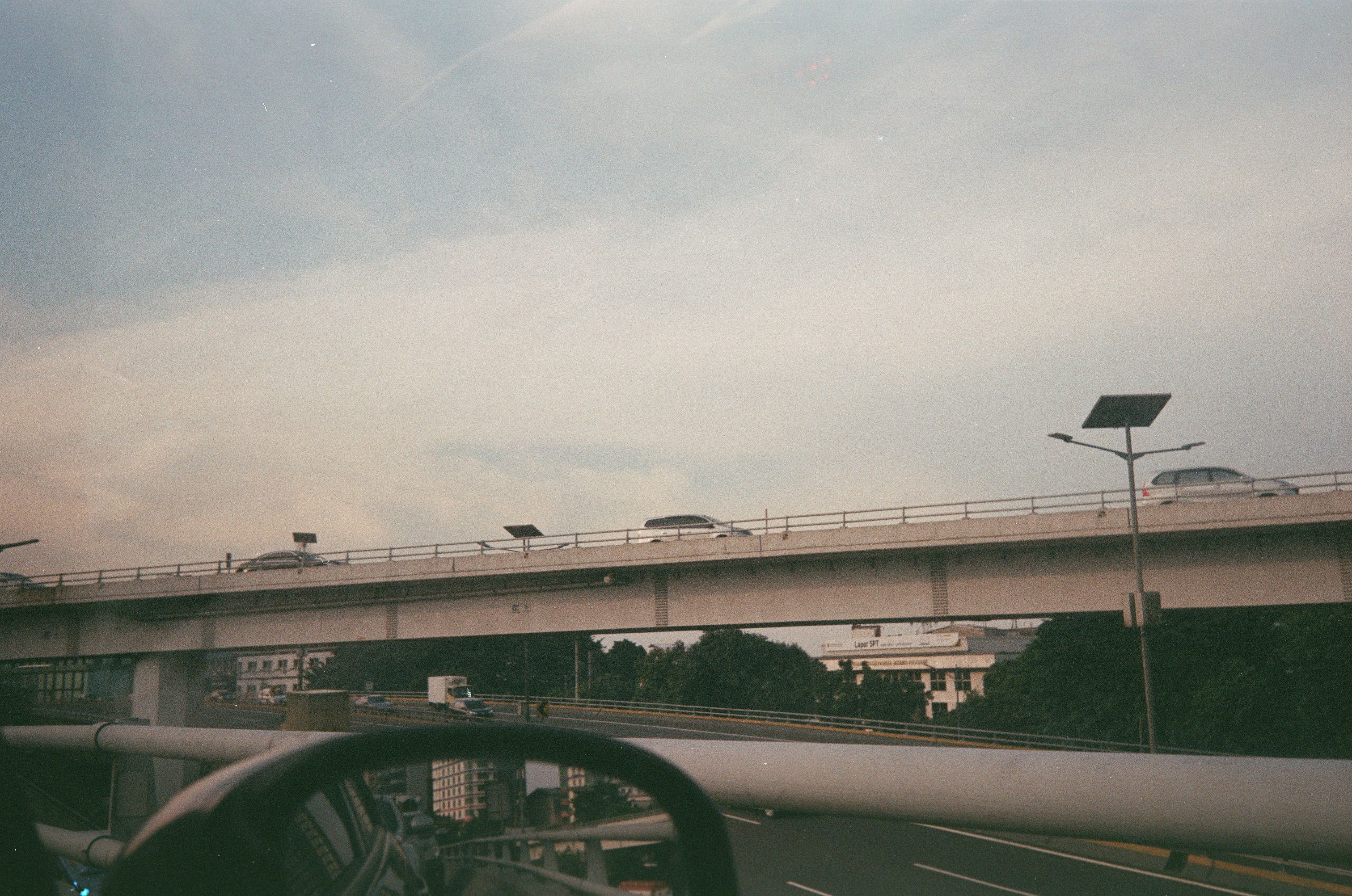 The Edappally junction flyover at dusk with mall lights and traffic below