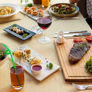 Restaurant table set for dinner, photo by Farhad Ibrahimzade on Pexels