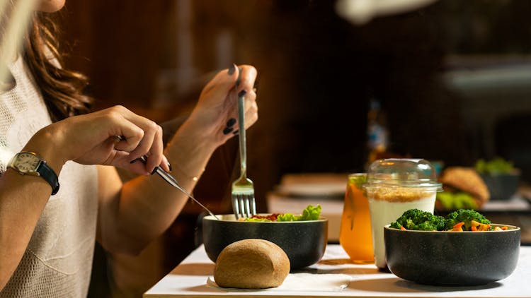 Person Holding Silver Fork And Knife