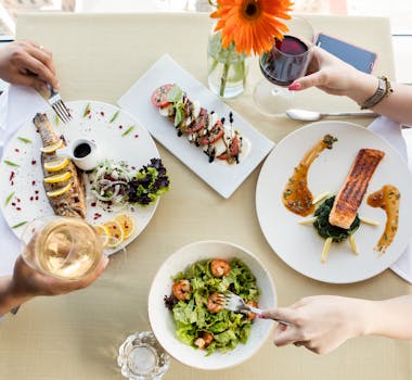 Top view of a gourmet seafood meal with wine and elegant plating.