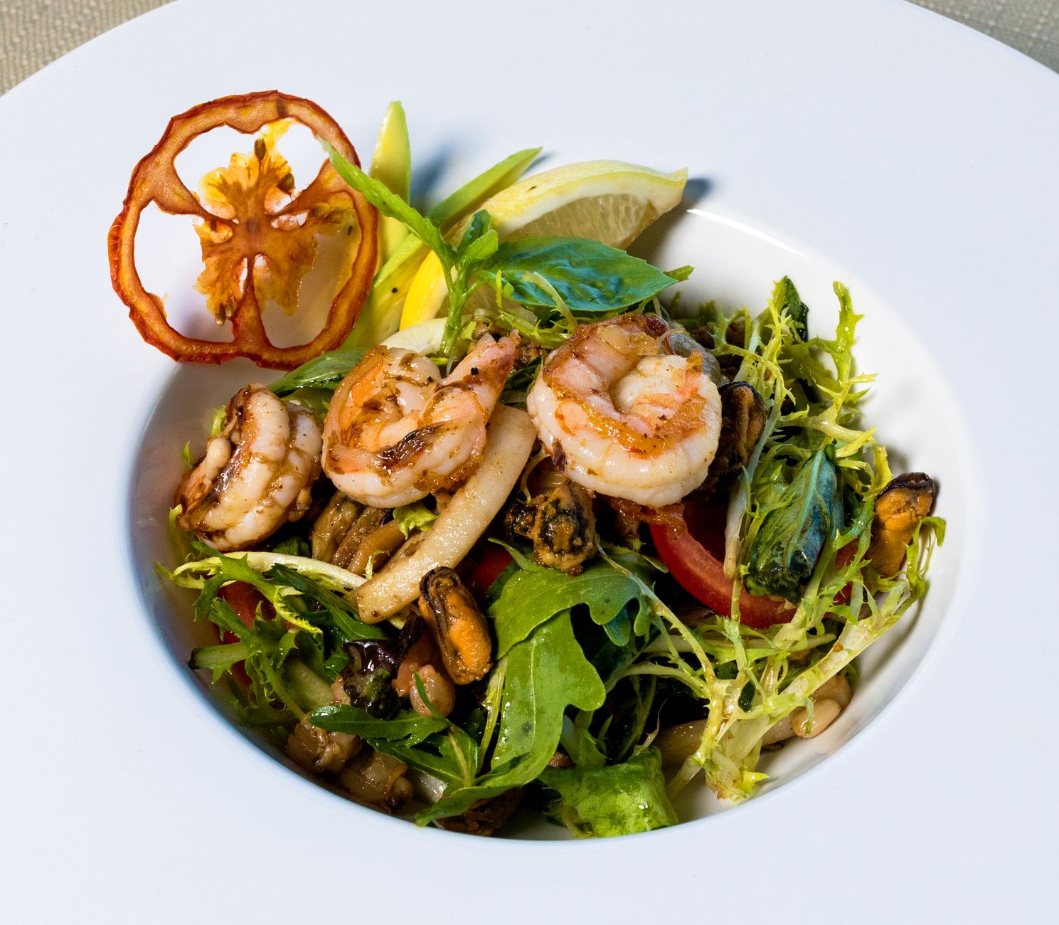 Fresh grilled vegetables salad served in a rustic bowl garnished with basil