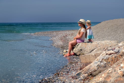 Mother and Daughter Sitting on the Shore