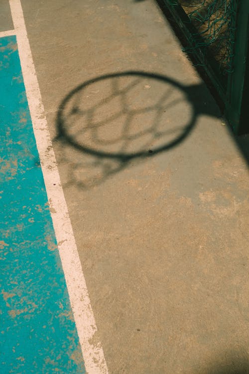 Free Shadow of a Basketball Hoop on the Court  Stock Photo