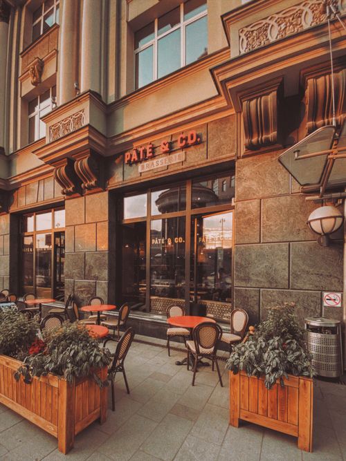 Free A picturesque café exterior in Moscow featuring warm tones and outdoor seating, ideal for relaxation. Stock Photo
