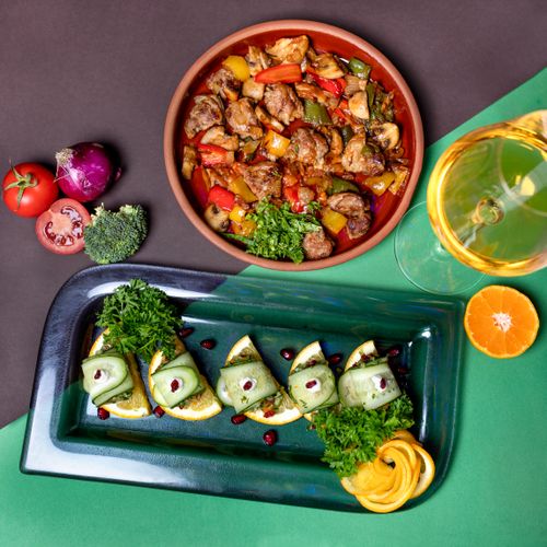 Free Vibrant Mediterranean dishes with fresh vegetables and herbs, perfect for a gourmet outdoor meal. Stock Photo