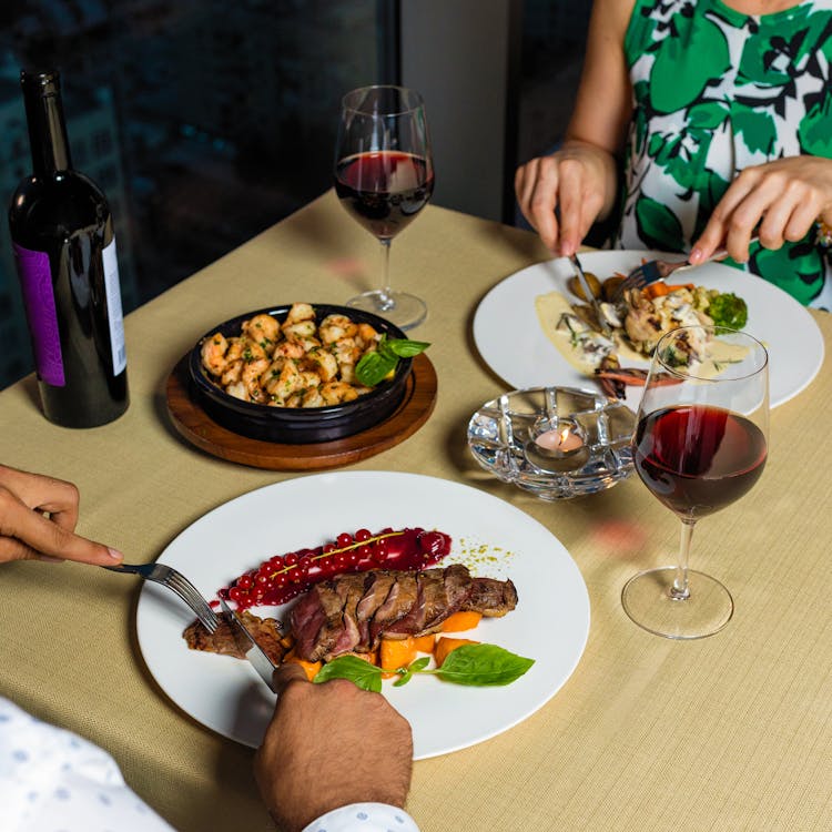 Couple Sitting And Eating Healthy Meals On A Dining Table