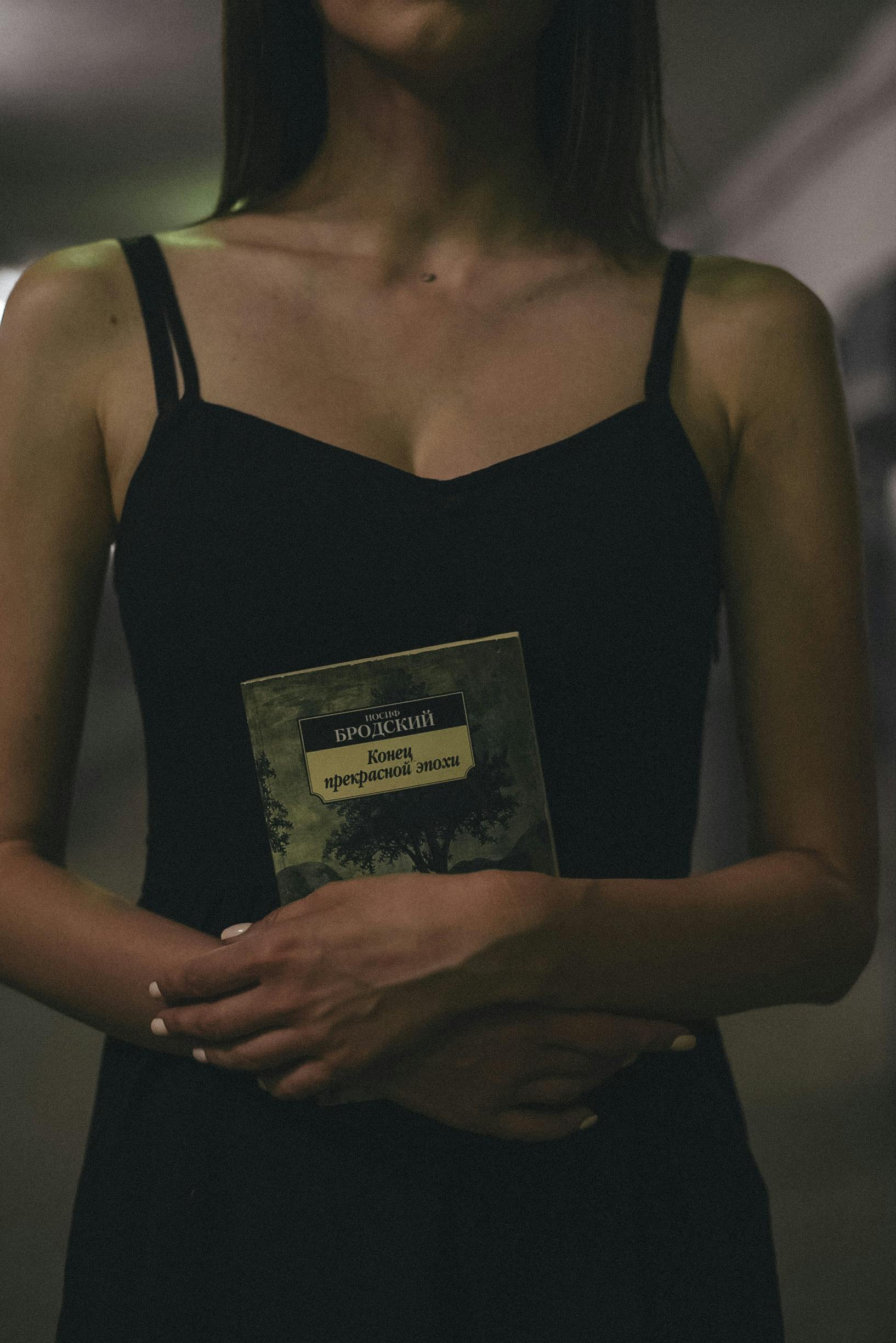 Woman In Black Spaghetti Strap Dress Holding A Book · Free Stock Photo