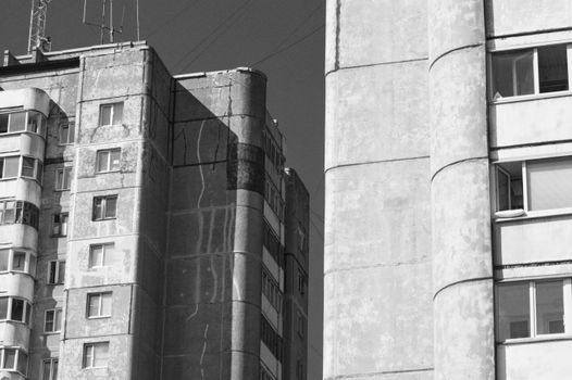Close-up view of urban high-rise buildings showcasing architectural details in black and white.