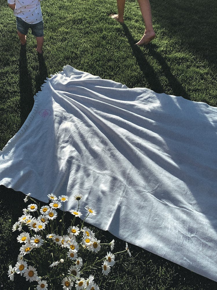 Blanket And Playing Kids Feet In Garden