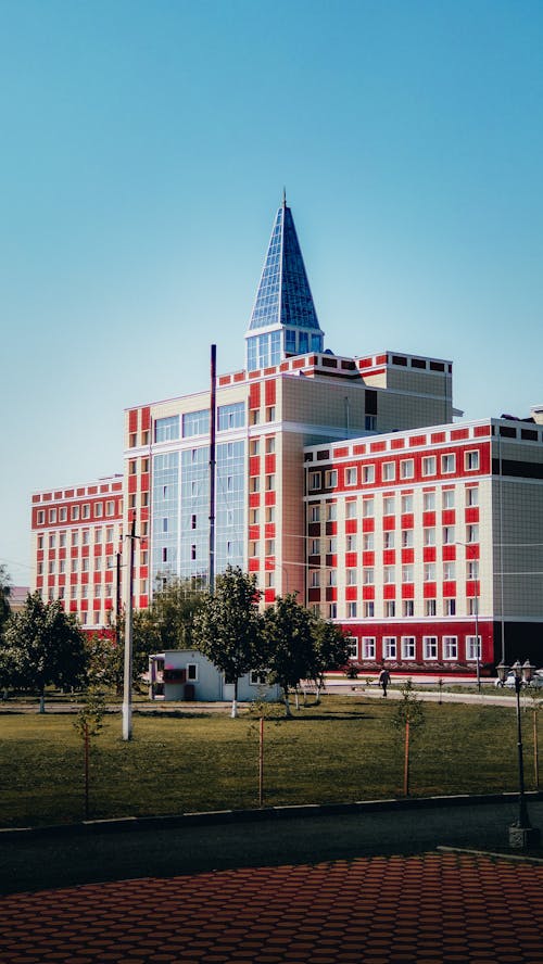 White and Red Concrete Building With Blue Tower