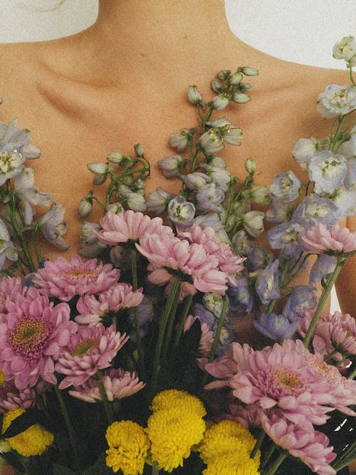 Free a Bunch of Flowers on a Woman's Chest Stock Photo