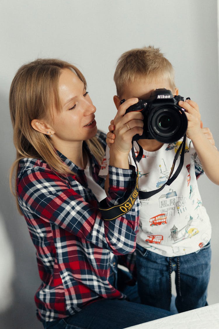 Woman And Child Holding A Camera