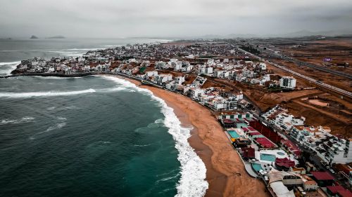Free Explore the breathtaking coastline in Peru with this stunning aerial cityscape. Stock Photo