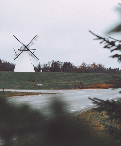 Windmill on Grass Field Near the River